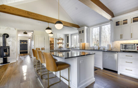 Kitchen with white cabinets and exposed beams